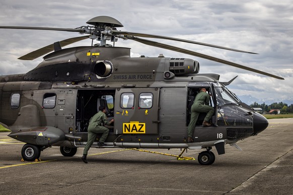 Specialists of Switzerland prepare a Super Puma Helicopter of the Swiss Air Force for take off during an international air radiometry exercise on the Duebendorf Military Air Base, on Monday, June 2, 2 ...