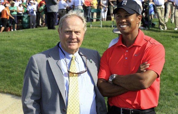 File-This June 3, 2012, file photo shows Jack Nicklaus, left, and Tiger Woods talking after Woods won the Memorial golf tournament at the Muirfield Village Golf Club in Dublin, Ohio. Nicklaus says he ...