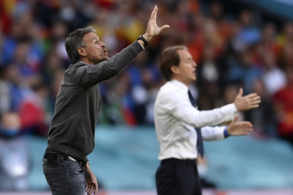 Spain&#039;s manager Luis Enrique, left, and Italy&#039;s manager Roberto Mancini give instructions during the Euro 2020 soccer semifinal match between Italy and Spain at Wembley stadium in London, Tu ...