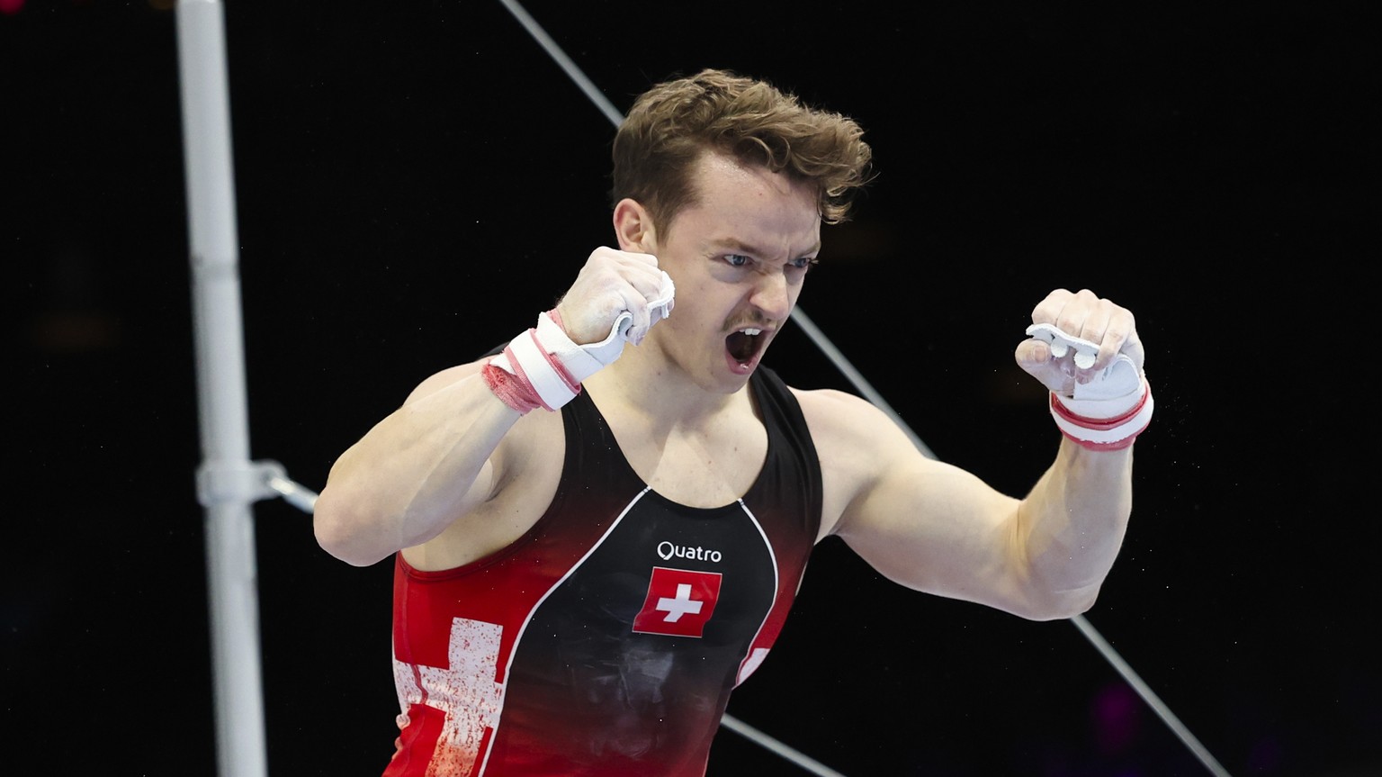 Switzerland&#039;s Christian Baumann gestures as he competes on the horizontal bar during the Men&#039;s team final at the Artistic Gymnastics World Championships in Antwerp, Belgium, Tuesday, Oct. 3, ...