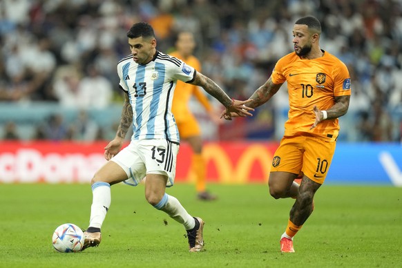 Argentina&#039;s Cristian Romero controls the ball as Memphis Depay of the Netherlands challenges during the World Cup quarterfinal soccer match between the Netherlands and Argentina, at the Lusail St ...