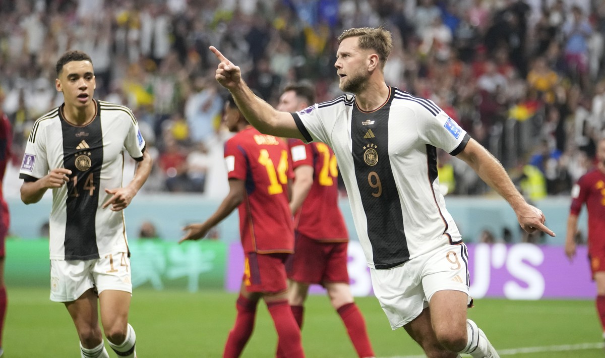 Germany's Niclas Fuellkrug celebrates after he scored his side's first goal during the World Cup group E soccer match between Spain and Germany, at the Al Bayt Stadium in Al Khor , Qatar, Su ...
