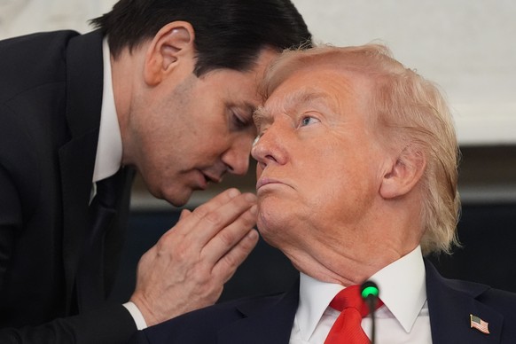 Secretary of State Marco Rubio whispers to President Donald Trump during a roundtable meeting on antifa in the State Dining Room at the White House, Wednesday, Oct. 8, 2025, in Washington. (AP Photo/E ...