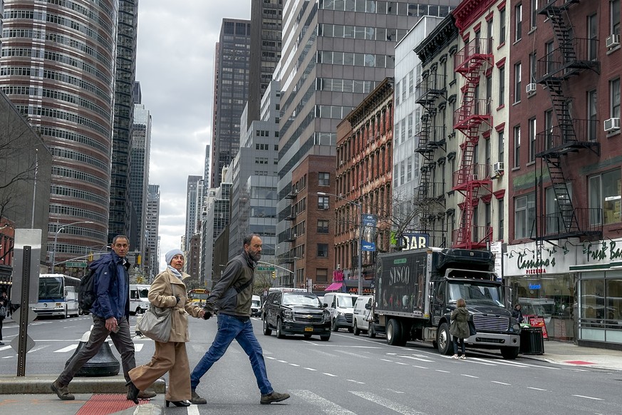 Pedestrians pass along 56th Street in Manhattan after an earthquake was felt along the eastern seaboard of the United States, Friday, April 5, 2024, in New York. (AP Photo/John Minchillo)