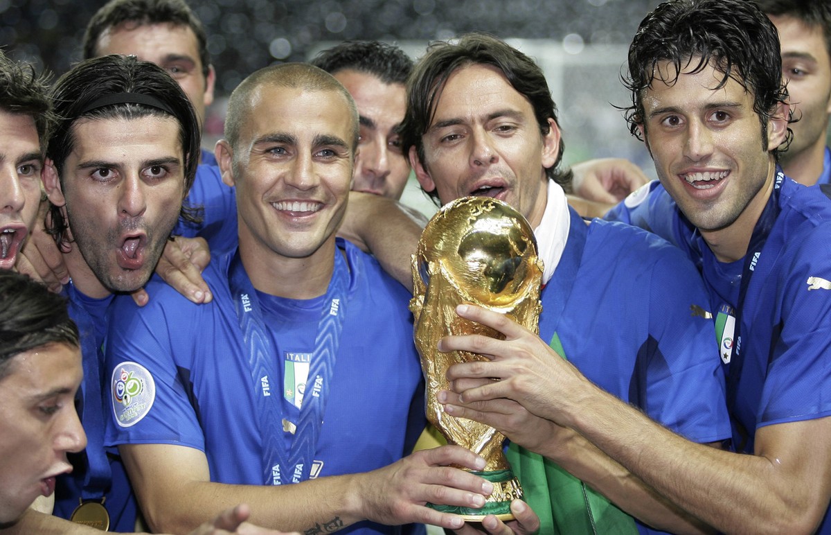 Italy's, from left, Vincenzo Iaquinta, Fabio Cannavaro, Filippo Inzaghi and Fabio Grosso celebrate with the World Cup trophy after the final of the soccer World Cup between Italy and France in th ...