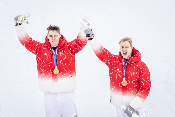 Gold medalist Franjo von Allmen of Switzerland, and bronze medalist Marco Odermatt of Switzerland, from left, pose on the podium after the men's alpine skiing Super-G race at the 2026 Olympic Win ...