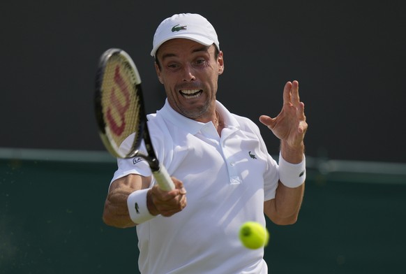 Spain&#039;s Roberto Bautista Agut plays a return to Germany&#039;s Dominik Koepfer during the men&#039;s singles third round match on day five of the Wimbledon Tennis Championships in London, Friday  ...