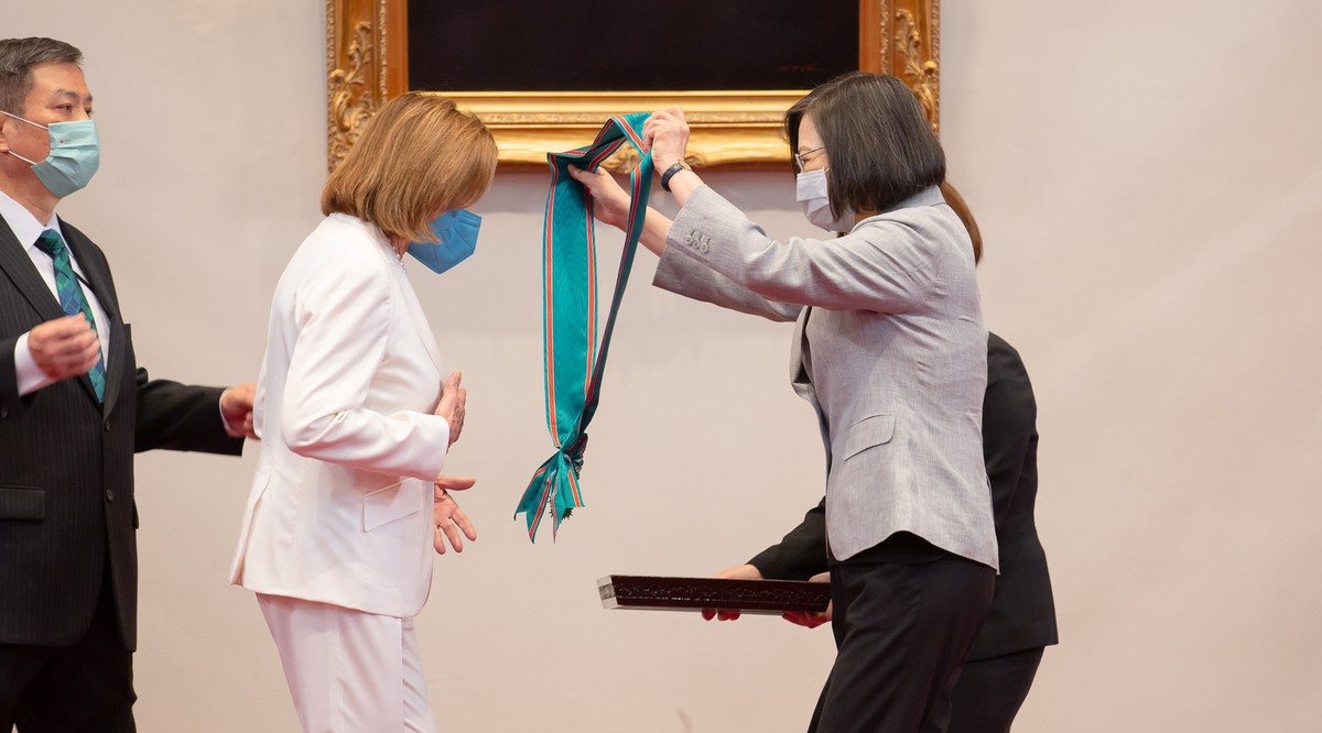 epa10103540 A handout photo made available by the Taiwan Presidential office shows Taiwan President Tsai Ing-wen (R) presenting US House Speaker Nancy Pelosi with a blue sash representing Taiwan' ...