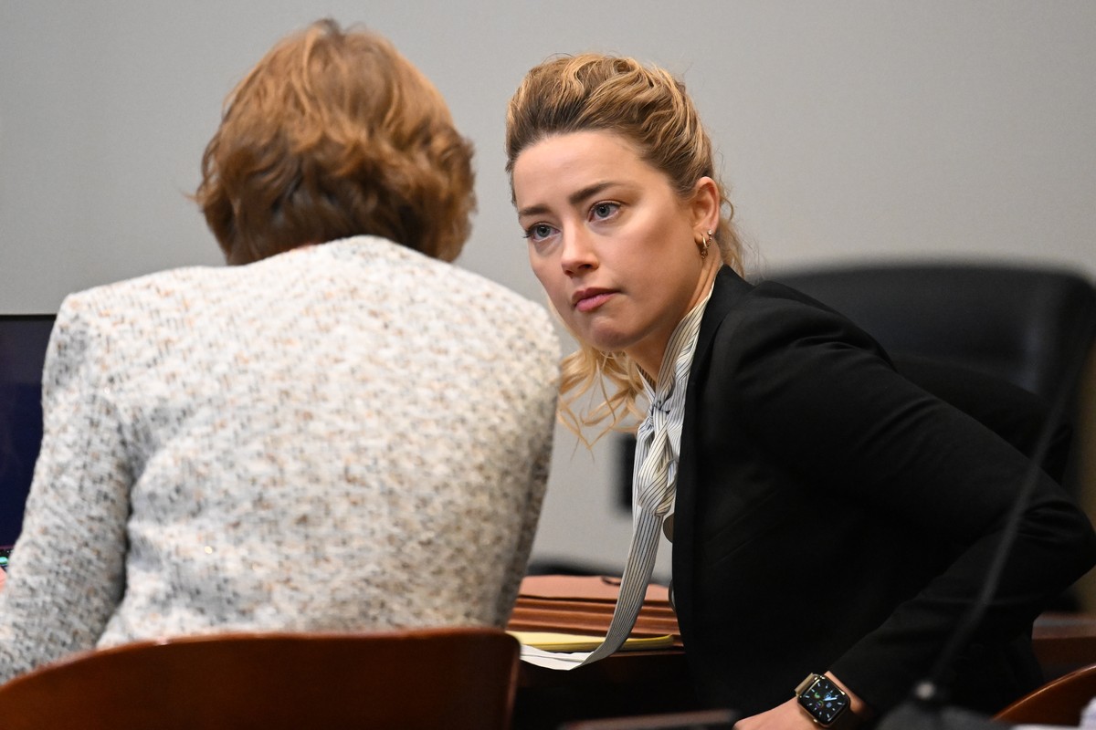epa09897211 US actress Amber Heard speaks to her attorney at the Fairfax County Circuit Courthouse in Fairfax, Virginia, USA, 19 April 2022. Johnny Depp's 50 million US dollars defamation lawsuit ...