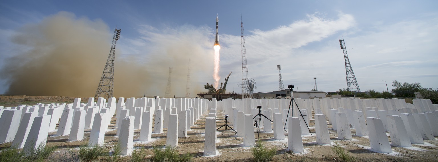 In this image released by NASA, the Soyuz-FG rocket booster with Soyuz MS-09 space ship carrying a new crew to the International Space Station, ISS, blasts off at the Russian leased Baikonur cosmodrom ...