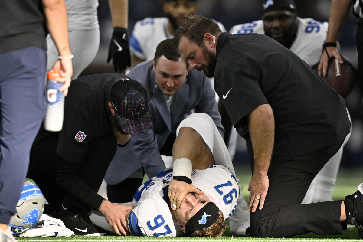 Detroit Lions defensive end Aidan Hutchinson (97) is attended to by team staff after suffering an unknown injury second half of an NFL football game against the Dallas Cowboys in Arlington, Texas, Sun ...