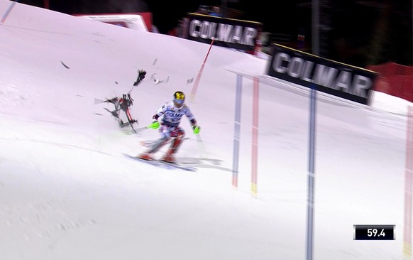 In this image taken from video a camera drone crashes into the snow narrowly missing Austria's Marcel Hirscher during an alpine ski, men's World Cup slalom, in Madonna Di Campiglio, Italy, T ...