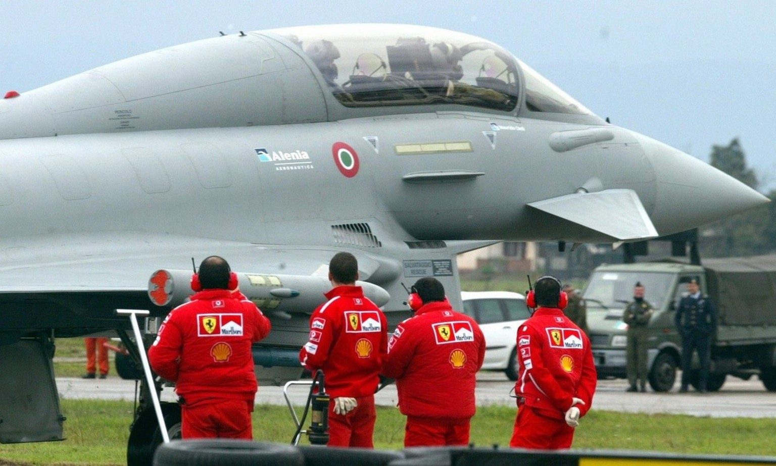 The Ferrari mechanics of German F1 driver Michael Schumacher inspect the Eurofighter jetplane prior to the race between the jet and Michael Schumacher in his Ferrari, Thursday 11 December 2003, at the ...