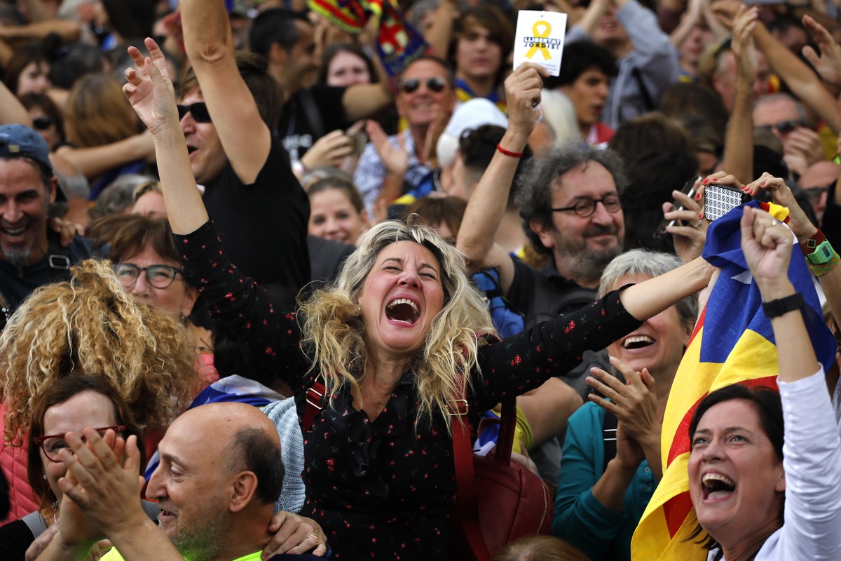 Maria Salut, 50, center, reacts as they celebrate the unilateral declaration of independence of Catalonia outside the Catalan Parliament, in Barcelona, Spain, Friday, Oct. 27, 2017. Catalonias' r ...