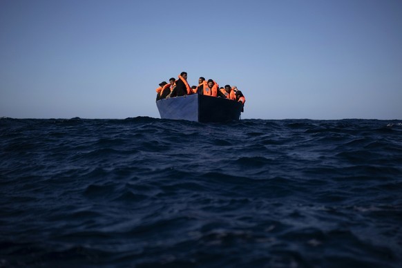 Migrants from Eritrea, Egypt, Syria and Sudan await aid from aid workers from Spanish NGO Open Arms, after fleeing Libya aboard a precarious wooden boat in the Mediterranean Sea about 11…