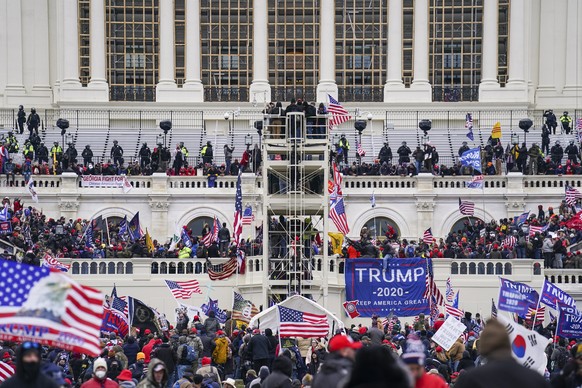 FILE - Insurrectionists loyal to President Donald Trump breach the Capitol in Washington, Jan. 6, 2021. Russell Taylor, a California man who stormed the U.S. Capitol and later testified against one of ...