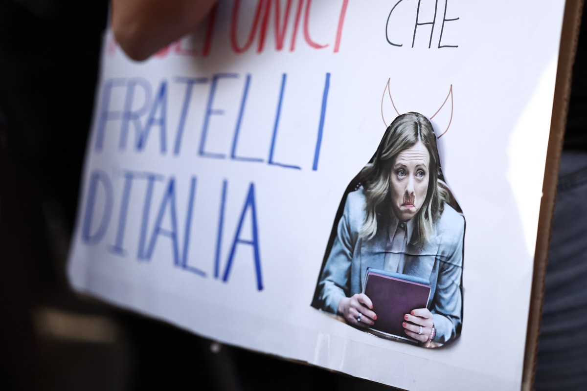 epa13329212 A demonstrator holds a placard featuring a caricature of Italian Prime Minister Giorgia Meloni during an anti-war rally in Rome, Italy, 24 October 2026. Thousands took part in coordinated  ...