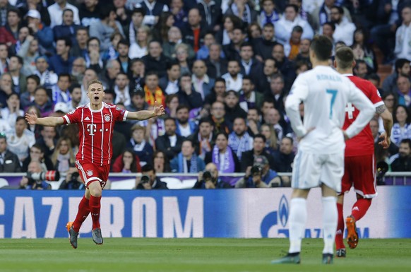 Real Madrid&#039;s Cristiano Ronaldo, second right, looks on as Bayern&#039;s Joshua Kimmich celebrates after scoring the opening goal during the Champions League semifinal second leg soccer match bet ...