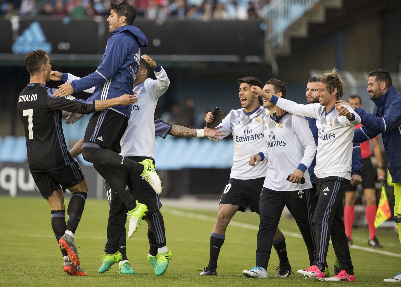Real Madrid&#039;s Cristiano Ronaldo, left, celebrates with teammates after scoring his first goal during a Spanish La Liga soccer match between Celta and Real Madrid at the Balaidos stadium in Vigo,  ...