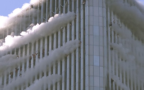 World Trade Center Hit by Two Planes
394263 07: (PUERTO RICO OUT) People hang from windows of World Trade Center after two planes hit the building September 11, 2001 in New York City. (Photo by Jose J ...