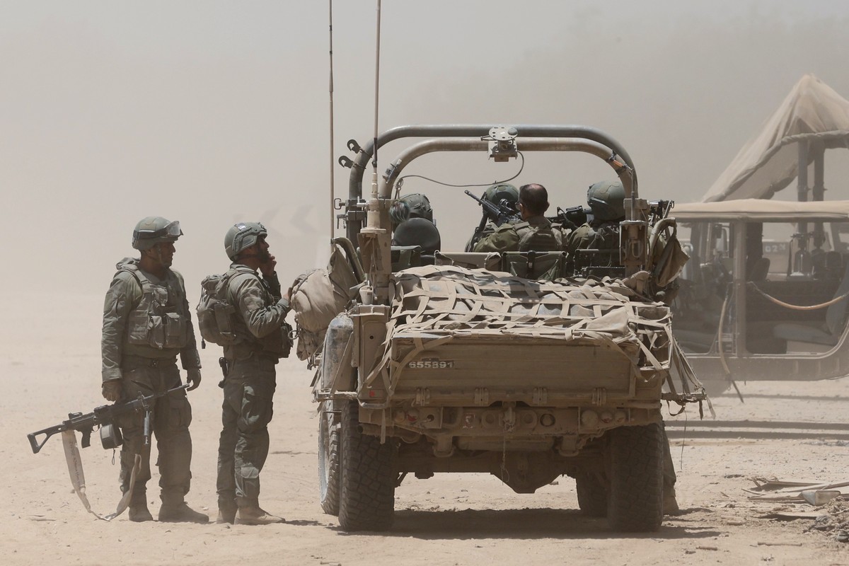epa11452020 Israeli soldiers with a military vehicle at an undisclosed location near the border with the Gaza Strip, southern Israel, 02 July 2024. The Israeli military stated on 02 July that it conti ...