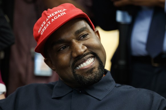 Rapper Kanye West smiles as he listens to a question from a reporter during a meeting in the Oval Office of the White House with President Donald Trump, Thursday, Oct. 11, 2018, in Washington. (AP Pho ...