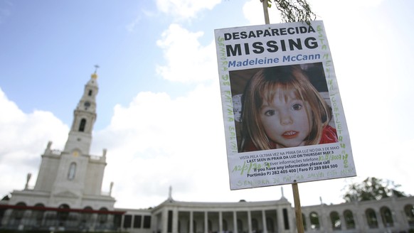 FILE - A picture of missing British girl Madeleine McCann, who disapeared from the Praia da Luz beach resort in the Algarve, is displayed at Our Lady of Fatima shrine Sunday, May 13 2007, in Fatima, n ...