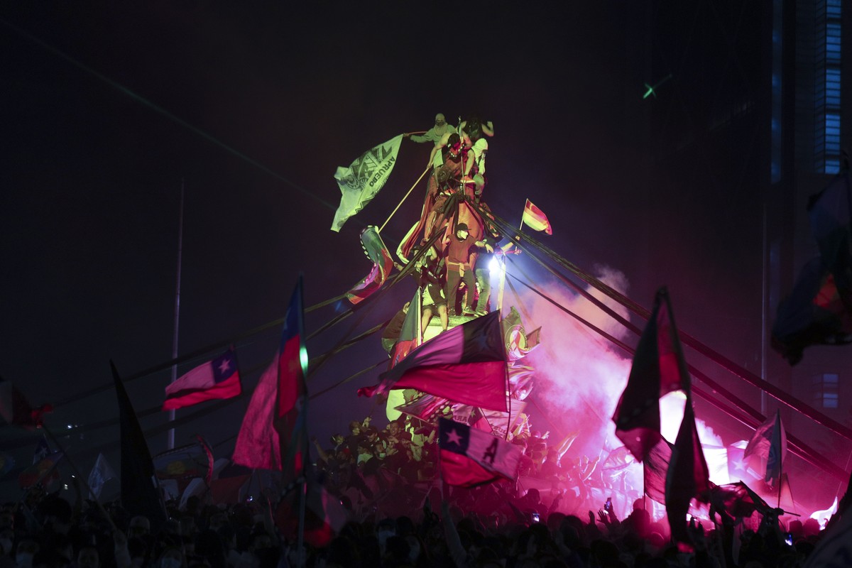 People gather at Plaza Italia on the day Chileans voted in a referendum to decide whether the country should replace its 40-year-old constitution, written during the dictatorship of Gen. Augusto Pinoc ...