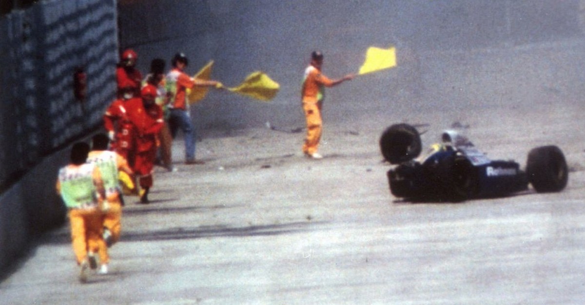 Race officials run toward Brazil's Aytron Senna after he crashed with his Williams-Renault during the San Marino F-1 Grand Prix in Imola Sunday May 1, 1994. Senna died at a Bologna hospital later ...