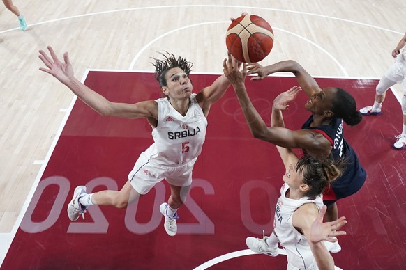 Serbia&#039;s Sonja Vasic (5) and Tina Krajisnik fight for a rebound with France&#039;s Sandrine Gruda, right, during the women&#039;s basketball bronze medal game at the 2020 Summer Olympics, Saturda ...