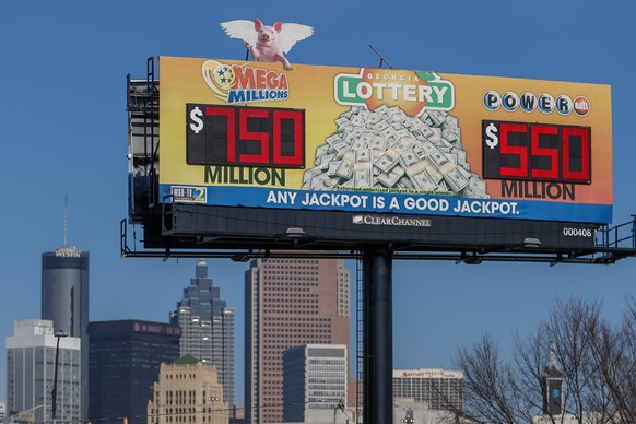 epa08935895 A billboard displays the Mega Millions (L) and Powerball (R) multi-state lottery jackpots in Atlanta, Georgia, USA, 13 January 2021. The Mega Millions jackpot has grown to an estimated 750 ...