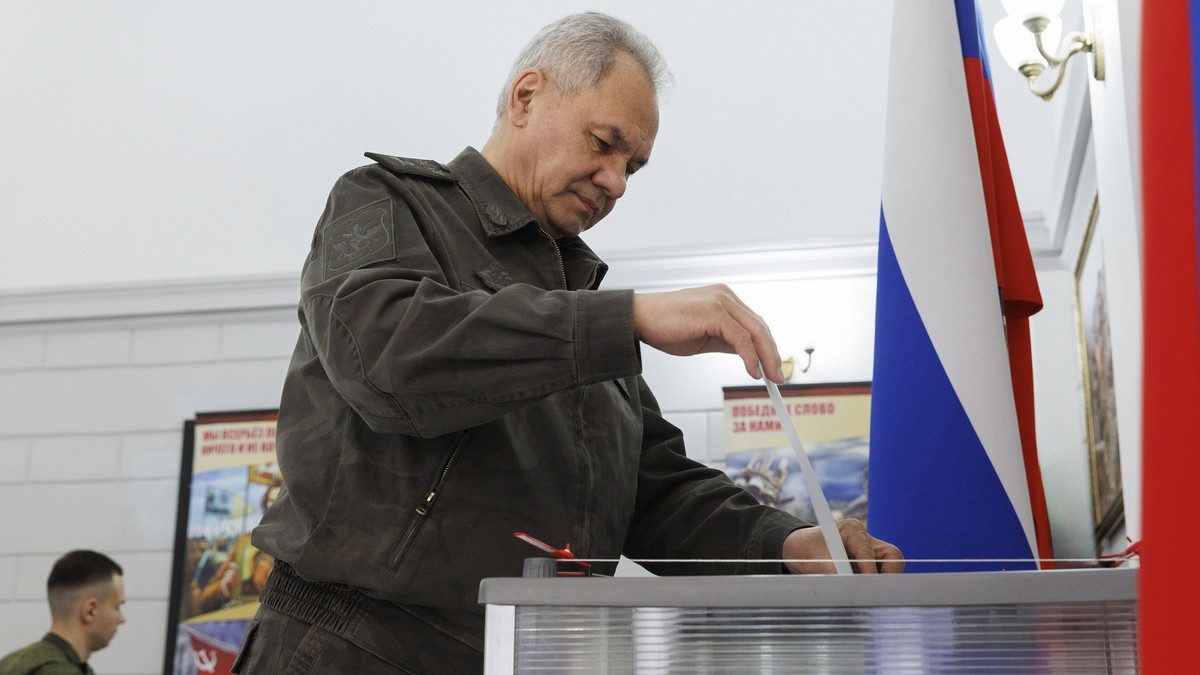 epa11222087 A handout photo made available by the Russian Defence ministry press-service shows Russian Defence Minister Sergey Shoigu casting his ballot during presidential elections at an undisclosed ...