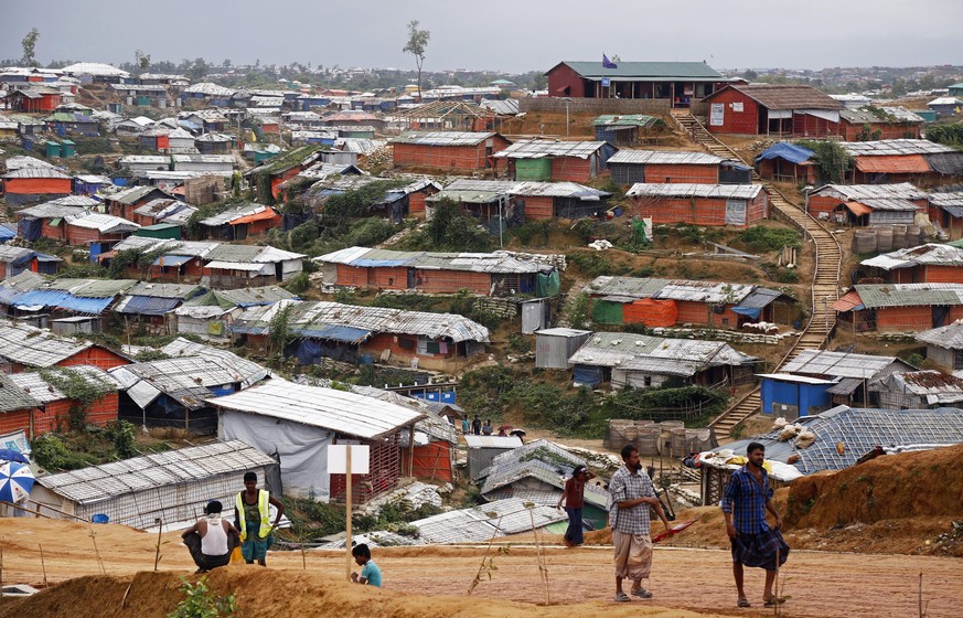 epa06973610 Rohingya refugees walk on a road along a makeshift camp in Kutubpalang, Cox Bazar district, Bangladesh, 26 August 2018. The day before marked the first anniversary of neighboring Myanmar&# ...