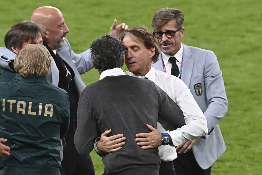 Italy&#039;s manager Roberto Mancini, 2nd right, embraces Spain&#039;s manager Luis Enrique at the end of the Euro 2020 soccer championship semifinal match between Italy and Spain at Wembley stadium i ...