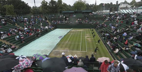 The covers are put on court 2 as rain falls on day eight at the Wimbledon Tennis Championships in London Tuesday, July 11, 2017. (AP Photo/Tim Ireland)