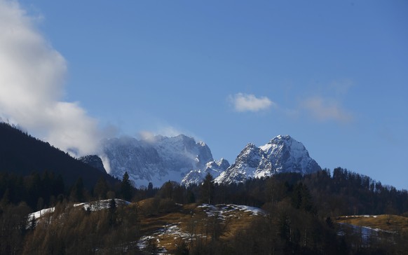 Germany's highest mountain, the 2,962 metre (9,718 feet) Zugspitze (L) is pictured from the Bavarian ski resort of Garmisch-Partenkirchen, Germany, January 29, 2016. The training session for the World Cup Men's Downhill was cancelled on Friday. REUTERS/Dominic Ebenbichler