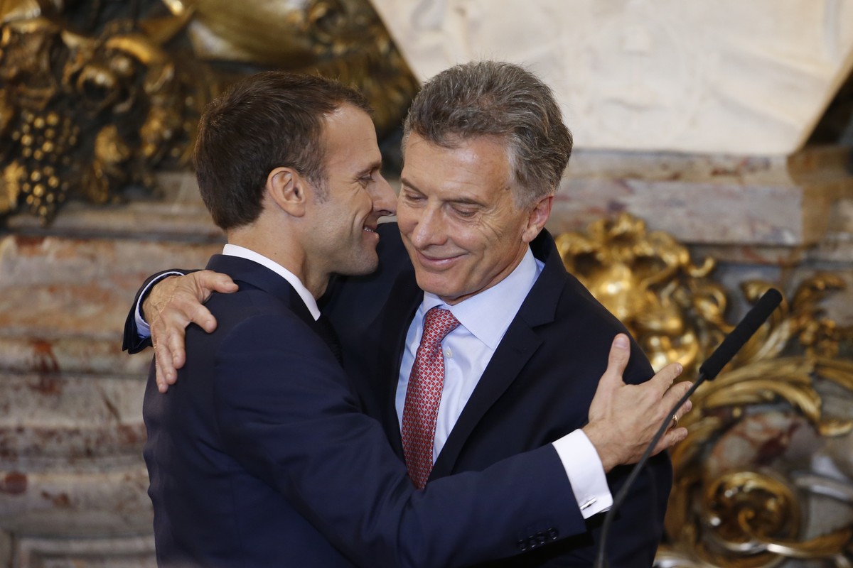 France's President Emmanuel Macron, left, and Argentina's President Mauricio Macri embrace after a joint press conference at the presidential palace in Buenos Aires, Argentina, Thursday, Nov ...