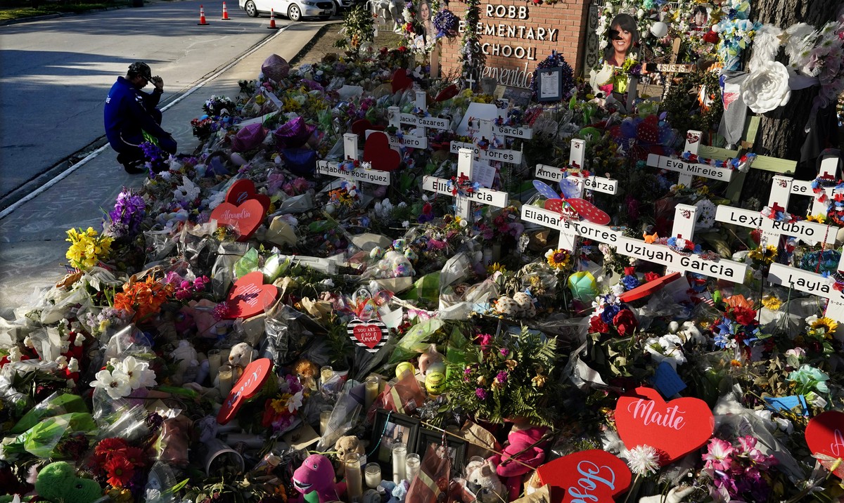 A man pays his respects at a memorial outside Robb Elementary School to honor the victims killed in last week's school shooting, Thursday, June 2, 2022, in Uvalde, Texas. (AP Photo/Eric Gay)