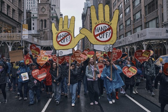 Protestors shout slogans as they take to the streets and march during a "Hands Off!" protest against President Donald Trump on Saturday, April 5, 2025, in New York. (AP Photo/Andres Kudacki) ...