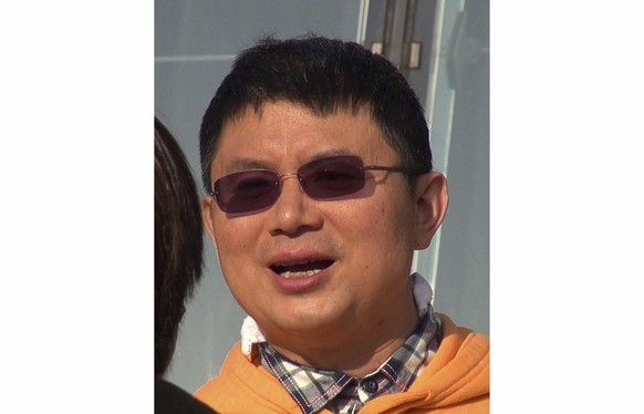FILE - Xiao Jianhua, a Chinese-born Canadian billionaire talks to reporters outside the International Finance Centre in Hong Kong in Dec., 2013. Xiao is being put on trial in China, Canada&#039;s gove ...