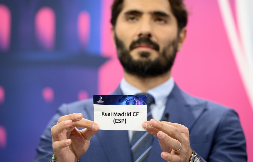 Turkish soccer player and ambassador for the UEFA Champions League final in Istanbul Hamit Altintop shows a ticket of Spain's soccer club Real Madrid CF during the UEFA Champions League 2022/23 round  ...