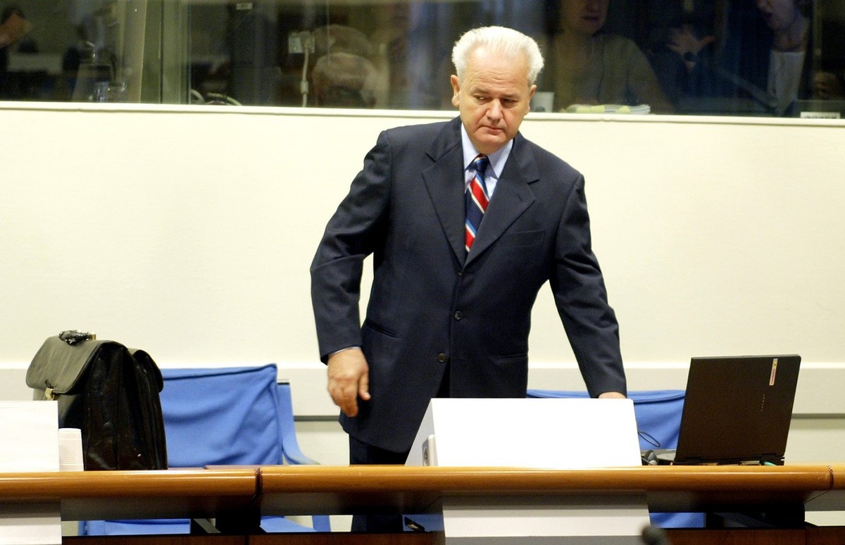 Former Yugoslav President Slobodan Milosevic enters a court room of the war crimes tribunal in The Hague, Tuesday Aug 31, 2004. Milosevic opened his defense case at the Yugoslav war crimes tribunal Tu ...