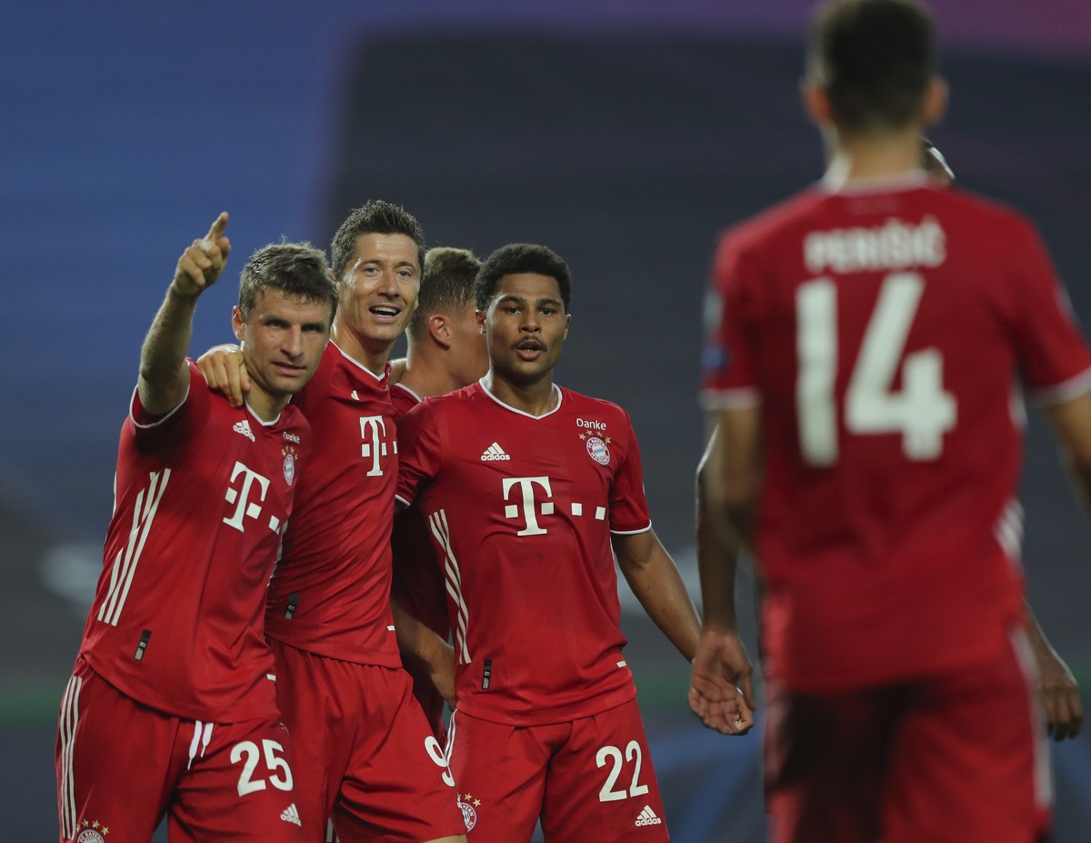 Bayern's Serge Gnabry, right, celebrates his side's second goal with teammates Robert Lewandowski, center, and Thomas Mueller during the Champions League semifinal soccer match between Lyon  ...