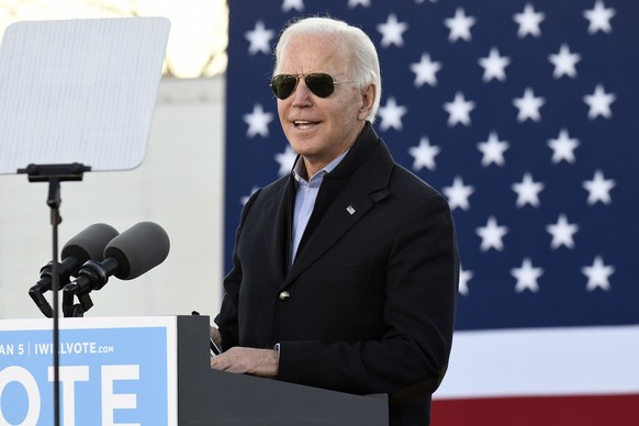 epaselect epa08919438 US President-elect Joe Biden appears during a campaign rally for Democrats Jon Ossoff and Raphael Warnock at the Georgia State University stadium parking lot in Atlanta, Georgia, ...