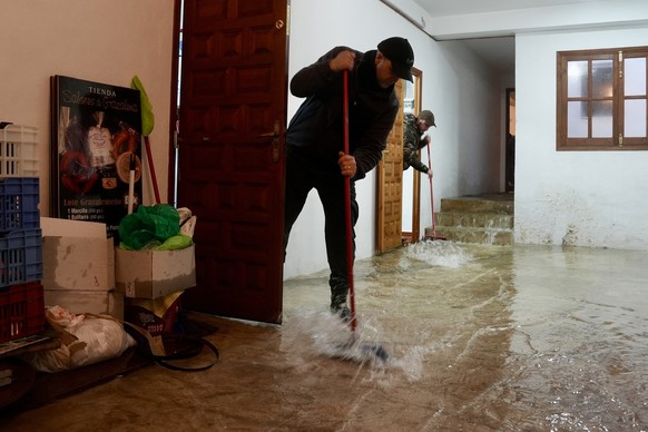 epa12704063 A man bails water out of his home after heavy rainfall in Grazalema, Cadiz, Andalusia, Spain, 04 February 2026. The Red Cross has mobilized volunteers from its Emergency Response Teams in  ...