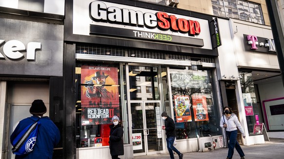 FILE - Pedestrians pass a GameStop store on 14th Street in Union Square, Thursday, Jan. 28, 2021, in New York's Manhattan borough.  The GameStop saga is being portrayed as a victory for the small…