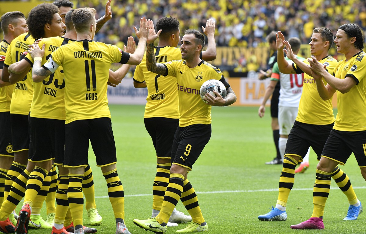 Dortmund's Paco Alcacer holds the ball as he celebrates after scoring his side's first goal during the German Bundesliga soccer match between Borussia Dortmund and FC Augsburg at the Signal  ...