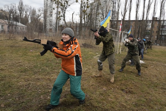 FILE - Civilians train with members of the Georgian Legion, a paramilitary unit formed mainly by ethnic Georgian volunteers to fight against Russian forces in Ukraine in 2014, in Kyiv, Ukraine, Feb. 1 ...