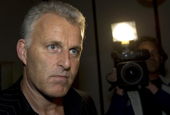 FILE - Dutch crime reporter Peter R. de Vries looks on, prior to attending a live TV show in Amsterdam, Netherlands, Thursday Jan. 31, 2008. Prosecutors say that two suspects in the slaying a year ago ...
