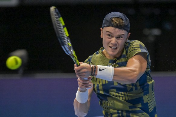 Denmark&#039;s Holger Rune returns a ball to Spain&#039;s Roberto Bautista Agut during their semifinal match at the Swiss Indoors tennis tournament at the St. Jakobshalle in Basel, Switzerland, on Sat ...